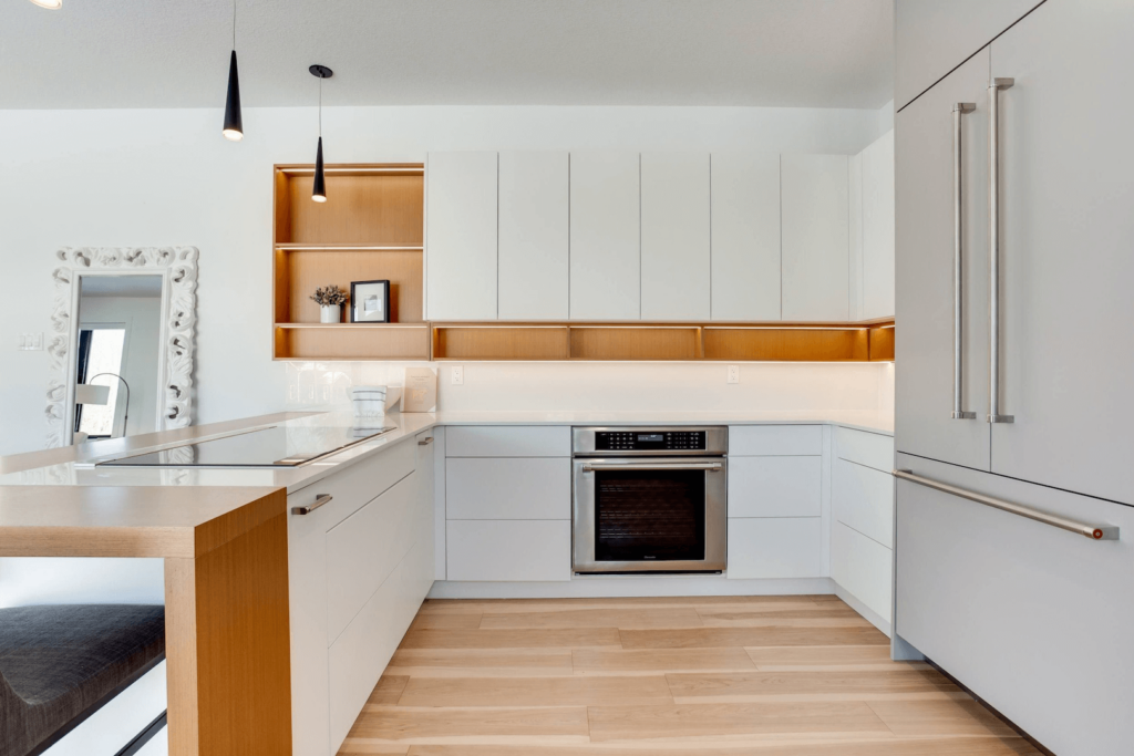 qmNA79-c Modern kitchen with white cabinetry, wooden accents, and stainless steel appliances, featuring a sleek design and open layout.